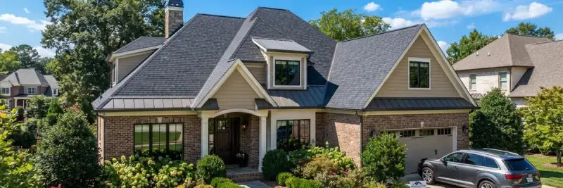 Two-storey suburban house with a newly finished asphalt shingle roof, dormers and metal accent roofing